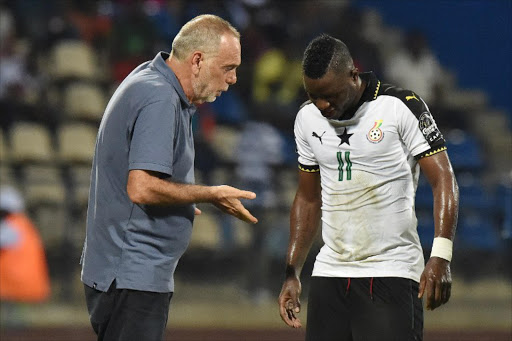 Ghana's Israeli coach Avram Grant (L) speaks to Ghana's midfielder Mubarak Wakaso during the 2017 Africa Cup of Nations semi-final football match between Cameroon and Ghana in Franceville on February 2, 2017.