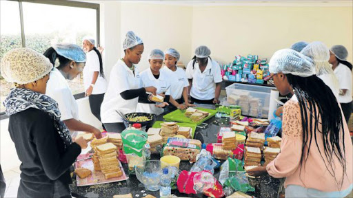 DOING THEIR BIT: Amaqhawekazi, a group of young girls prepare 1 000 ‘love sandwiches’ for the less fortunate youth in East London’s Nompumelelo informal settlement Picture: SISIPHO ZAMXAKA