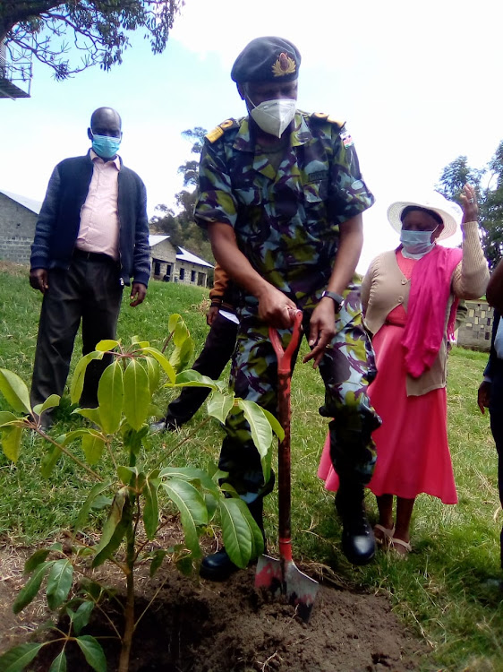 KDF Chief of Infrastructure Brigadier Dennis Kamuri plants a tree during the commissioning of the Kaimbaga health centre borehole on Tuesday, August 25, 2020