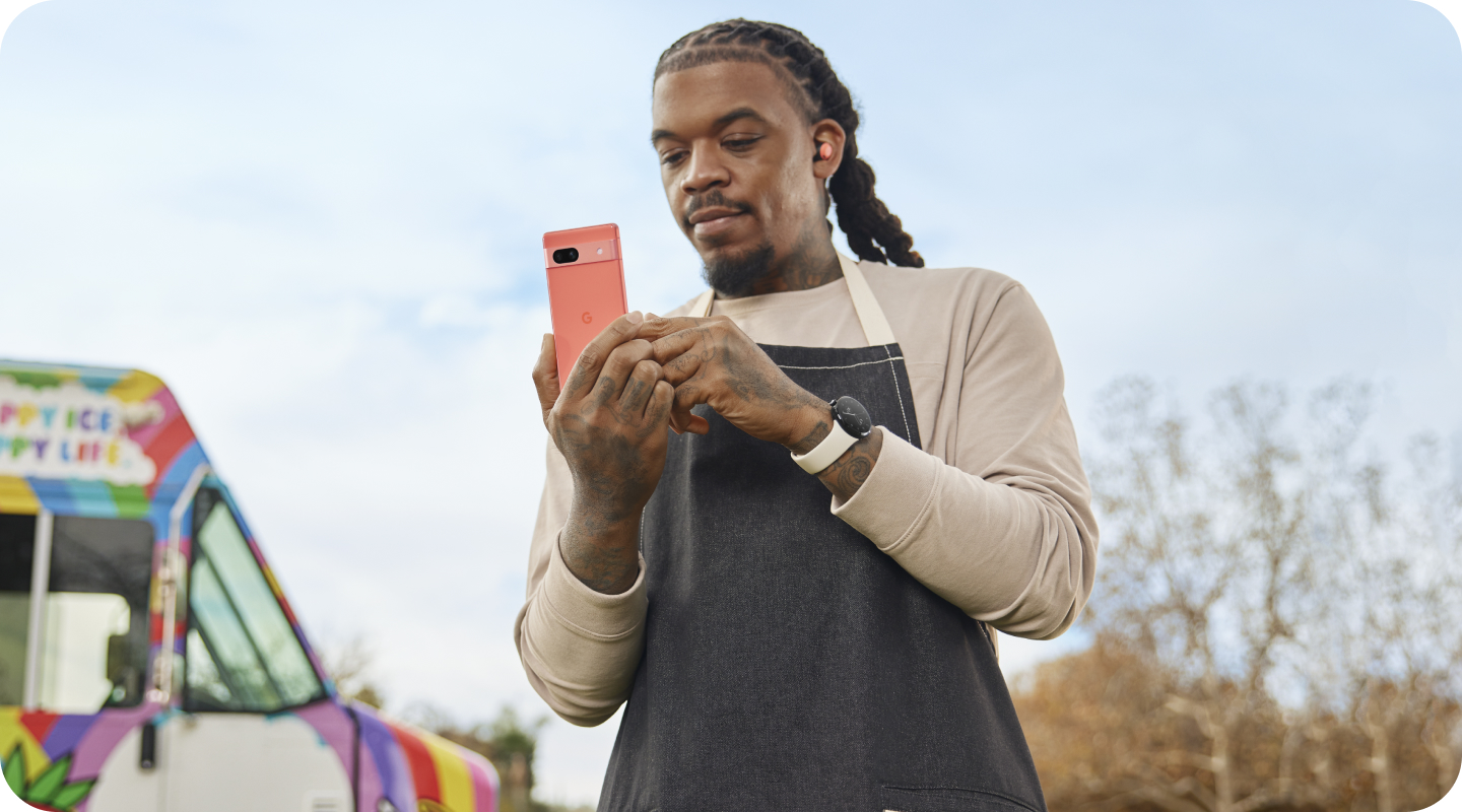 A small business owner working on his Google Pixel 7a phone.