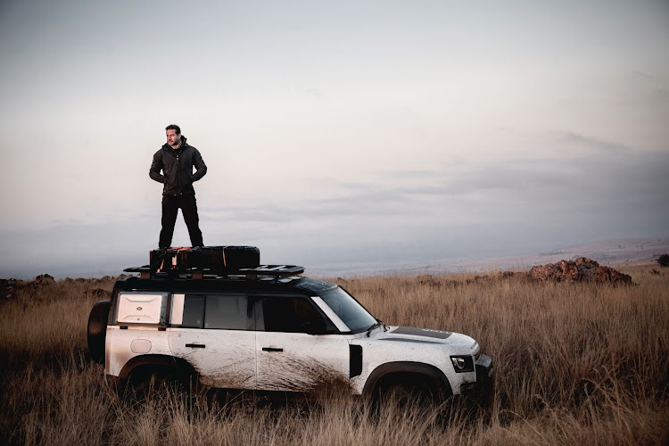 Ross Holgate surveys the terrain from the roof of his 2020 Land Rover Defender.