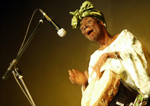 Iconic Swahili traditional music Taarab star, Zanzibar's Bi Fatuma Binti Baraka, but popularly known as Bi Kidude, performs during a show in Nairobi, Kenya 13 October 2006 with part of her group of dancers.
