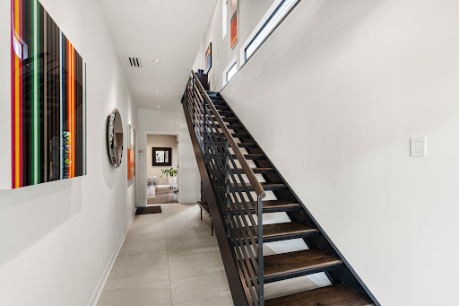 Modern hallway with wooden staircase in this luxury house for sale in Houston ($899,000)