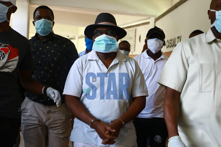 Kilifi deputy governor Gideon Saburi being escorted out of the Coast General Hospital after being arrested on April 3, 2020.