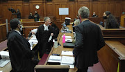 British American Tobacco SA lawyer Alfred Cockrell, centre, told the Cape Town high court that the billions of rand lost to the fiscus during the ban on the sale of tobacco products 'could have been used to combat the effects of the pandemic, for example by erecting field hospitals'.