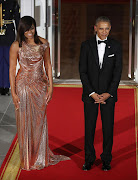 U.S. President Barack Obama and first lady Michelle Obama wait for the arrival of Italian Prime Minister Matteo Renzi and his wife Mrs. Agnese Landini, for a state dinner at the White House, October 18, 2016 in Washington, DC.