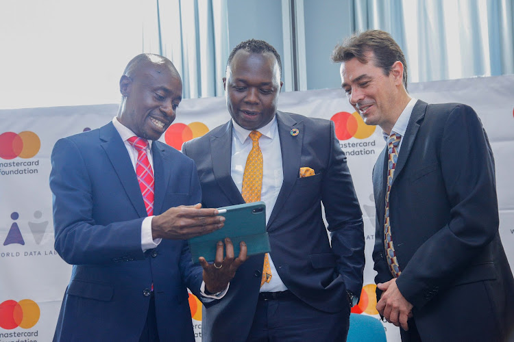 Mastercard Foundation Country director Kenya, David Bagenda share a light moment with Secretary for Youth Affairs, Raymond Ouma and CEO World Data Lab, Wolfgang Fengler at the official launch of the Africa Youth Employment Clock in Nairobi.