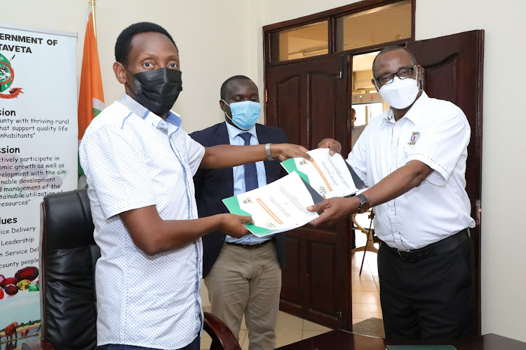 Taita Taveta Governor Granton Samboja with the Kenya Institute of Highways & Building Technology Deputy Director Geoffrey Githiri at his Mwatate office.