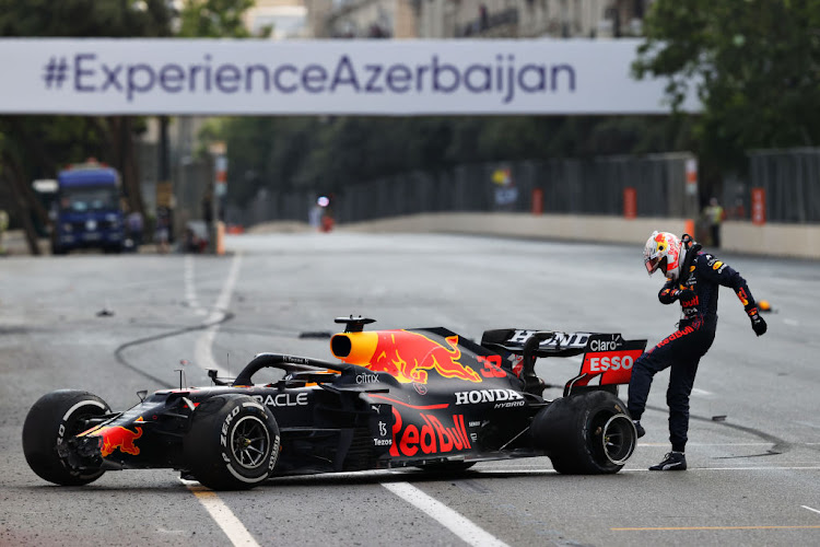 Max Verstappen of Netherlands and Red Bull Racing kicks his tyre as he reacts after crashing during the F1 Grand Prix of Azerbaijan at Baku City Circuit on June 06, 2021 in Baku, Azerbaijan.