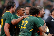 Springboks players celebrate with replacement back Willie le Roux after he scored a late try to down New Zealand during their Rugby Championship clash at Mbombela Stadium.