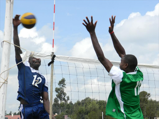 Kiptolo Jepochok of co-operative spikes the ball against Peterson Kimani of Forest Rangers in their opening math of KVF fourth leg in Eldoret last season./FILE