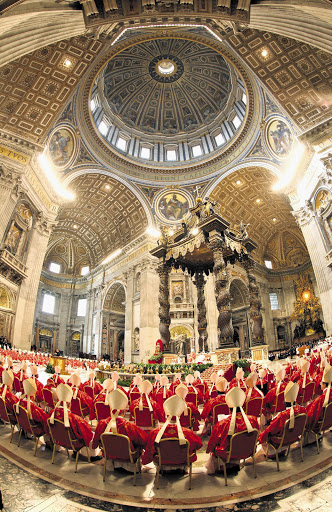 Cardinals attend Mass at St Peter's Basilica yesterday before entering the conclave to decide who the next pope will be