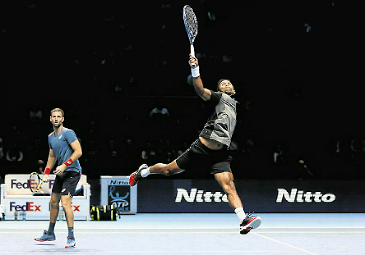 SA’s Raven Klaasen goes high to get to the ball as Michael Venus of New Zealand looks during their doubles round-robin match against Nikola Mektic of Croatia and Alexander Peya of Austria at the ATP World Tour Finals November 13, 2018 in London