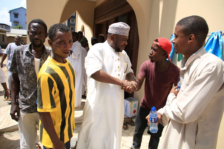 Jomvu MP Badi Twalib and his supporters outside the Jamia Mosque Mikindani on Friday.