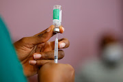 A nurse prepares a dose of the Covid-19 vaccine during the vaccination campaign at the Ridge Hospital in Accra, Ghana, on March 2 2021. 