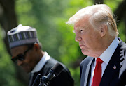 Donald Trump and Nigeria’s President Muhammadu Buhari hold a joint news conference in the Rose Garden at the White House in Washington in 2018. Despite Trump's previous disparaging comments about Africans, millions in Nigeria are said to love the bombastic 45th U.S. president all the same.