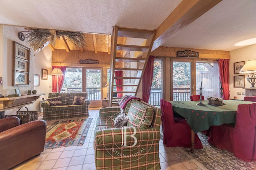 Buy this luxury property in Megeve (74120) - Living room with fireplace and dining area