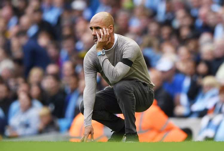 Pep Guardiola, manager of Manchester City reacts during a match.