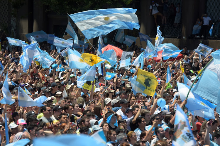 Supporters of Javier Milei wave flags and banners during the presidential inauguration ceremony at the National Congress in Buenos Aires, Argentina, December 10 2023. Picture: MARCELO ENDELLI/GETTY IMAGES