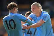 Jack Grealish of Manchester City celebrates with Erling Haaland of Manchester City during the Premier League match between Wolverhampton Wanderers and Manchester City at Molineux on September 17, 2022 in Wolverhampton, United Kingdom. 