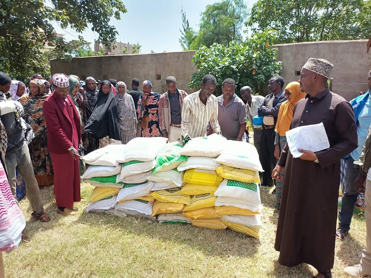 Saku subcounty administrator Shukri Ibrahim presides over the distribution of relief food to urban poor