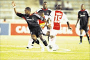 WRONG TURN: Orlando Pirates' Lindokuhle Mkhwanazi comes second best in a tussle for possession with Ajax Cape Town's Mkhanyiseli Siwahla during the Absa Premiership match at Johannesburg Stadium on Saturday. 07/12/08. Pic. Antonio Muchave. © Sowetan.