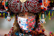 A participant in a traditional costume wearing a face mask attends a rehearsal for Garba, a folk dance, ahead of Navratri, a festival during which devotees worship the Hindu goddess Durga and youths dance in traditional costumes, amidst the coronavirus disease (COVID-19) outbreak, in Ahmedabad, India, September 12, 2020. 