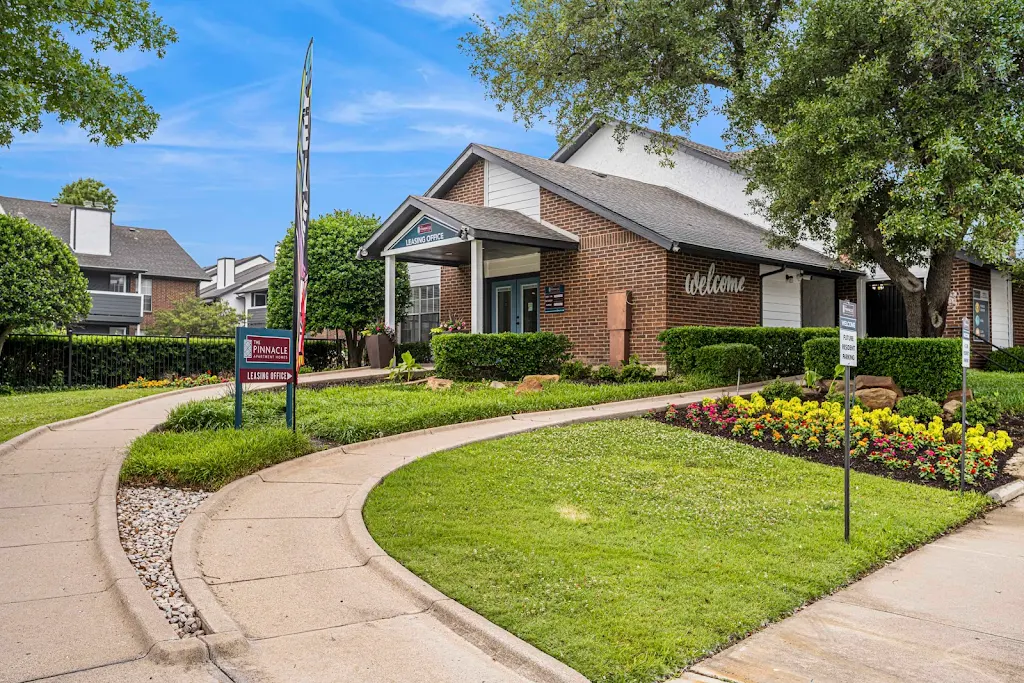 Entrance to the leasing office with landscaping