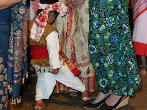 A three-year-old boy attempts stepping on Kate's feet at a fireside festival. Photo/DAILY MAIL