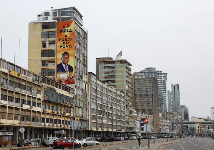 A billboard with the face of Angola's President and leader of the People's Movement for the Liberation of Angola (MPLA) ruling party Joao Lourenco is seen on dilapidated buildings during the general election in the capital Luanda.