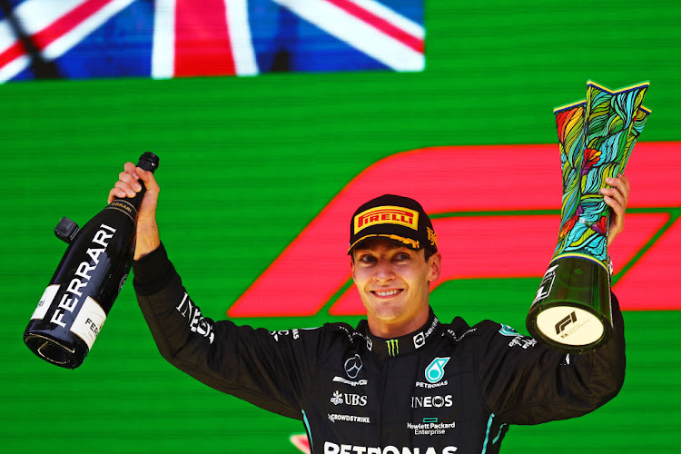 Race winner George Russell celebrates on the podium during the F1 Grand Prix of Brazil at Autodromo Jose Carlos Pace on November 13 2022 in Sao Paulo.