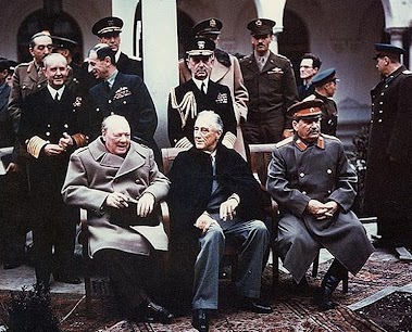 The 3 men pictured in the first row, from left, were Winston Churchill (England), F.D.R. (USA), and Joseph Stalin (Russia). While Russia is sometimes considered an adversary of the USA today, it served as an ally of the USA in fighting against Hitler and the Nazis from the east.