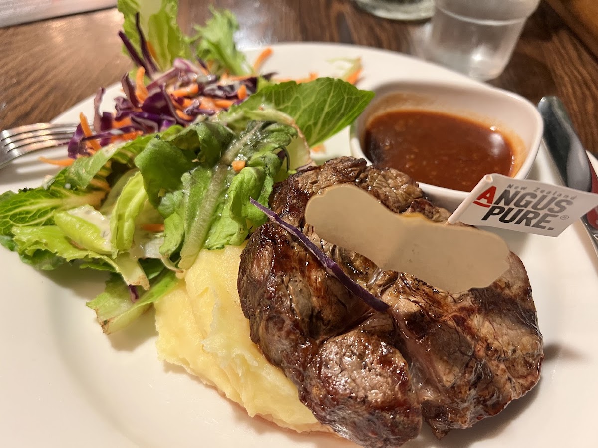 Scotch fillet with potato mash and green salad, with BBQ sauce