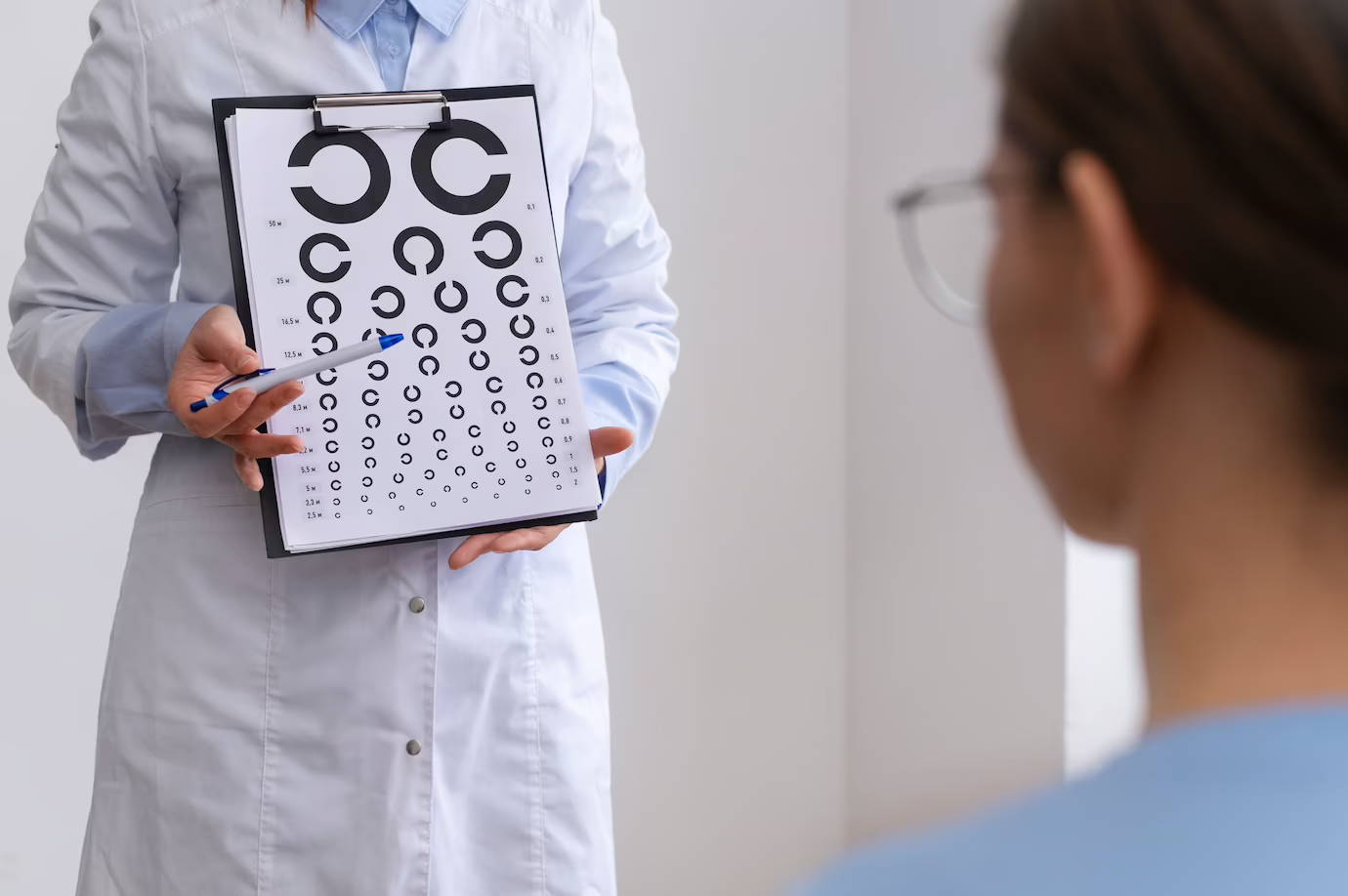 A dedicated doctor evaluates a patient's eyesight by using a chart, ensuring precise vision assessment and care.