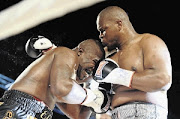 Osborne Machimana, right,  punishes Elvis Moyo during their clash at the Sandton Convention Centre. Machimana says he lost the fight to Ruann Visser because he was unfit. 