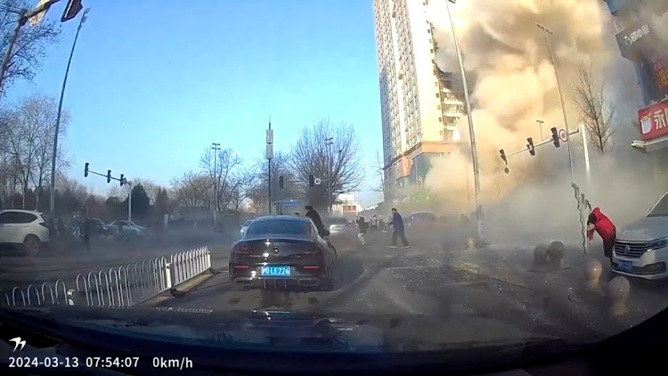 A dashcam view shows people fleeing following an explosion in Sanhe, Langfang City, Hebei Province, China in this screen grab from video obtained by Reuters March 13, 2024.