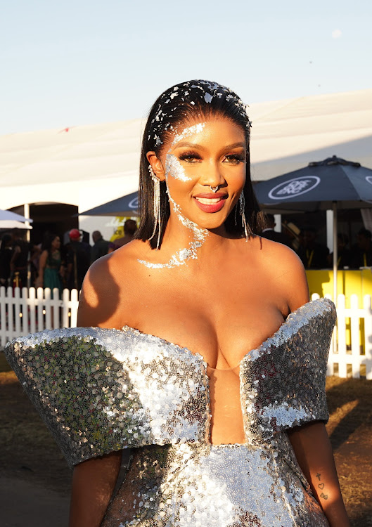 Actor Lunathi Mampofu shimmered in a slick back hairdo with silver metallic flakes at the Durban July in Durban.