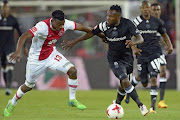 Mpho Makola of Orlando Pirates fights for possession with Isaac Nhlapo of Ajax Cape Town during the Absa Premiership match between Orlando Pirates and Ajax Cape Town at Orlando Stadium on September 12, 2017 in Johannesburg.