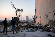 People look at the damaged port area following a massive explosion, in Beirut, Lebanon, on August 14 2020.