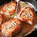 Pork Chops in Creamy Garlic &amp; Herb Wine Sauce was pinched from <a href="https://whatsinthepan.com/pork-chops-in-creamy-white-wine-sauce/" target="_blank" rel="noopener">whatsinthepan.com.</a>