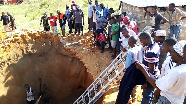 locals rescuing three people after a 20-foot pit latrine collapsed at Madibwani primary in Matuga sub-county on April, 2020.