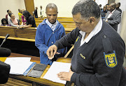 Mvumeleni Jezile's fingerprints being taken after he was sentenced. File photo.