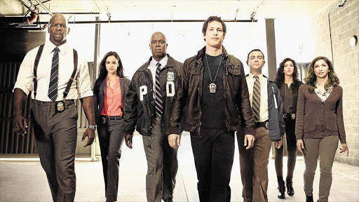 POLICE PRESENCE: Andre Braugher and Andy Samberg, third and fourth from left, are the axles around which 'Brooklyn Nine-Nine' spins.