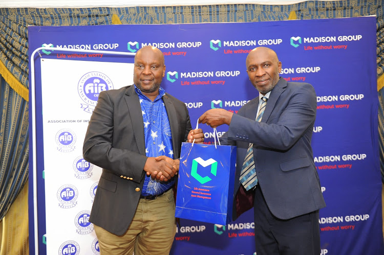 Madison General Insurance Kenya Managing Director Samuel Chege {right} presents a token of appreciation to Association of Insurance Broker of Kenya National Chairman Anthony Mwangi during a breakfast meeting at Sarova Stanley Hotel on May 17,2024