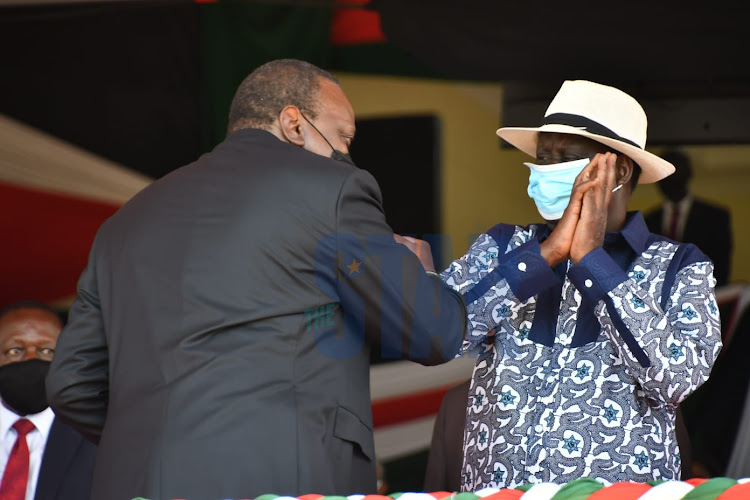 President Uhuru Kenyatta greets ODM party leader Raila Oginga at the Madaraka Day celebrations