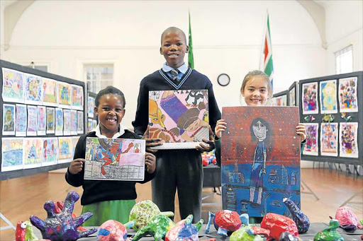 BIG YEAR: Mbalentle Ondala, eight, of Cambridge Primary, Thulani Mayiphume, 14, of Khayalethu Special School and Jenna Muller, nine, of Stirling Primary, whose artworks have been selected for an insurance giant’s 2017 calendar Picture: SIBONGILE NGALWA