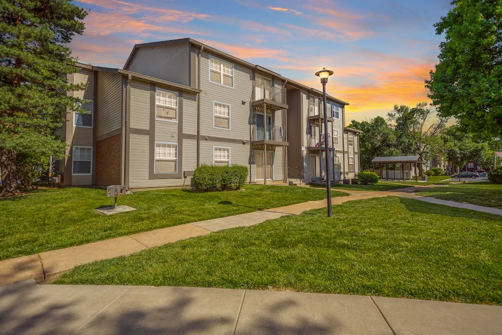 University Commons apartment building with light siding at dusk