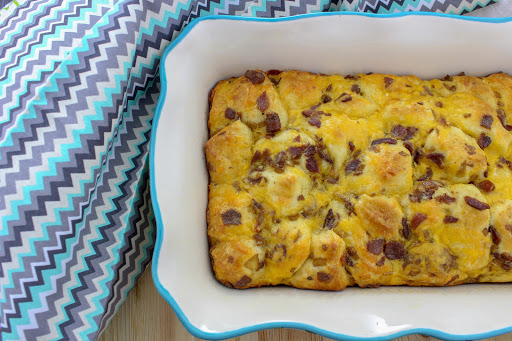 Bacon biscuit breakfast bake in a casserole dish.