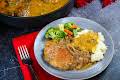 Jamie's Smothered Pork Chops On A Plate With Mashed Potatoes And Vegetables.