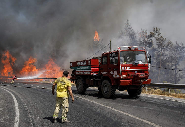 Firefighters try to extinguish a wildfire near Marmaris, Turkey, August 1 2021. Picture: REUTERS/UMIT BEKTAS